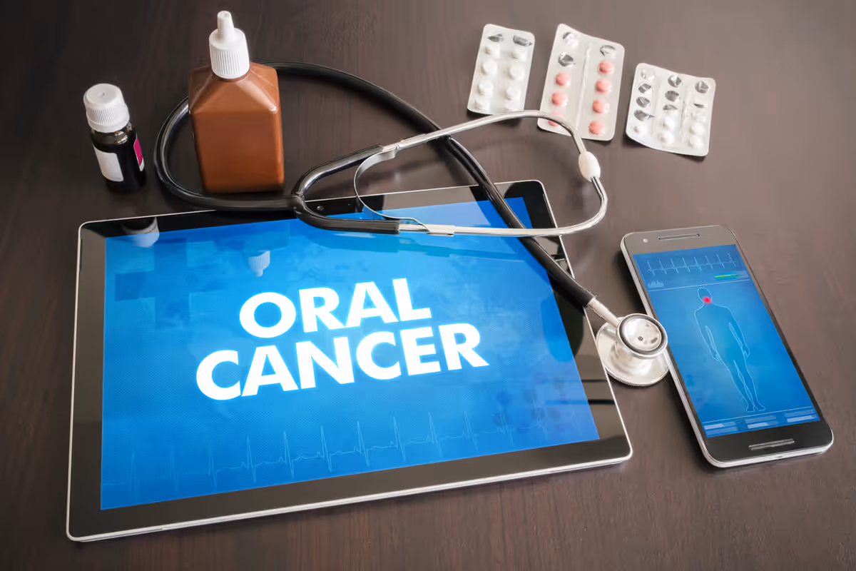 Oral cancer screening resources on a tablet beside clinical instruments