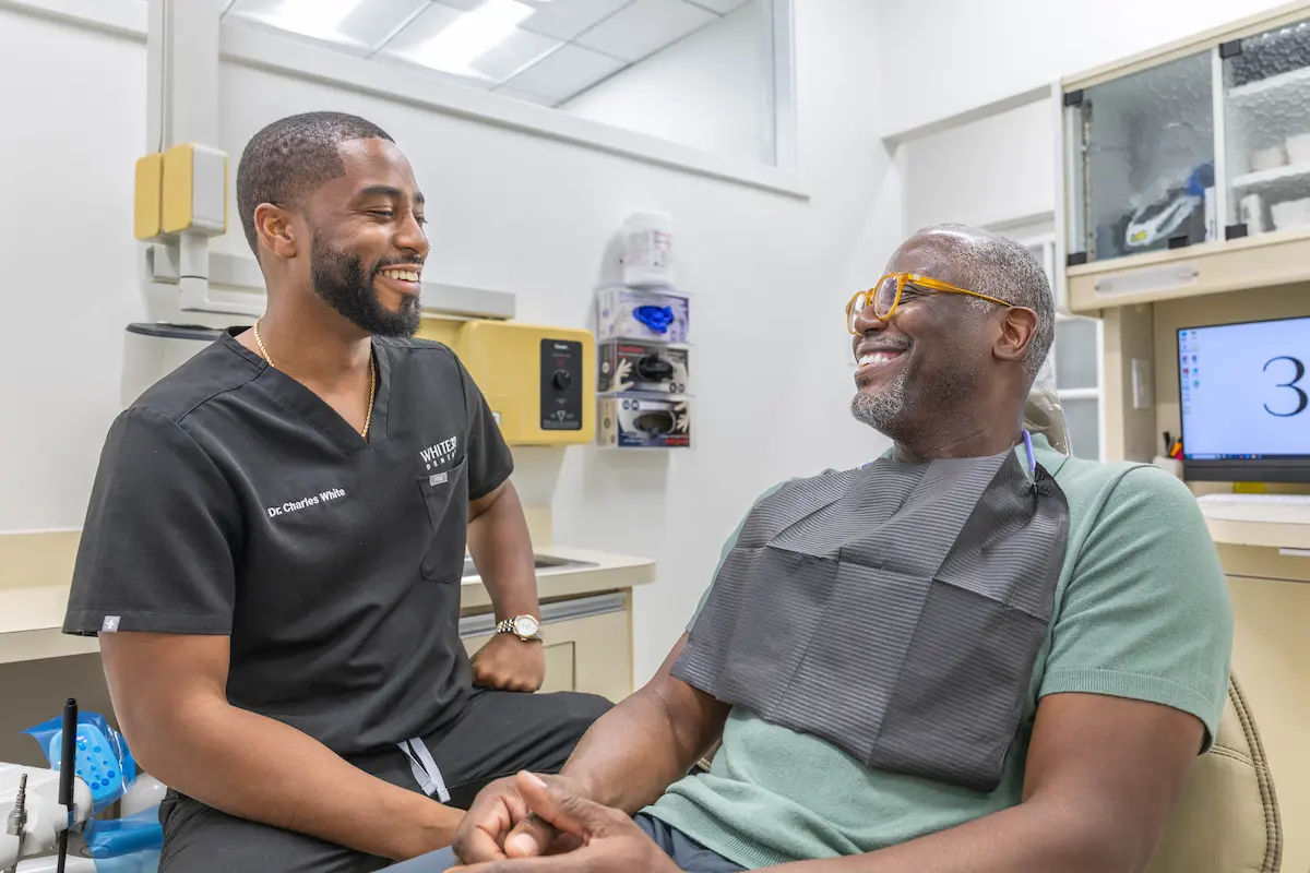 Dr. Charles White laughing with a patient at White32 Dental