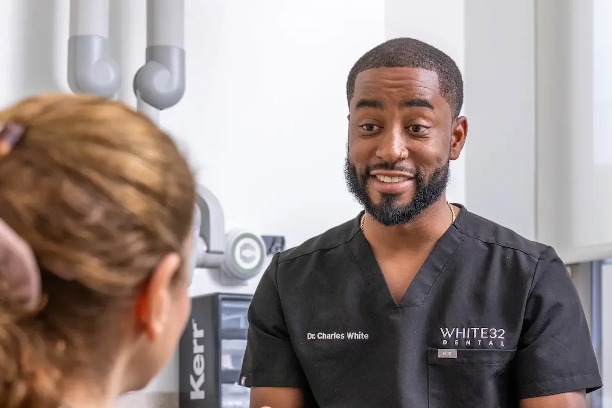 Dr. Charles White talking with a patient during a general dentistry visit