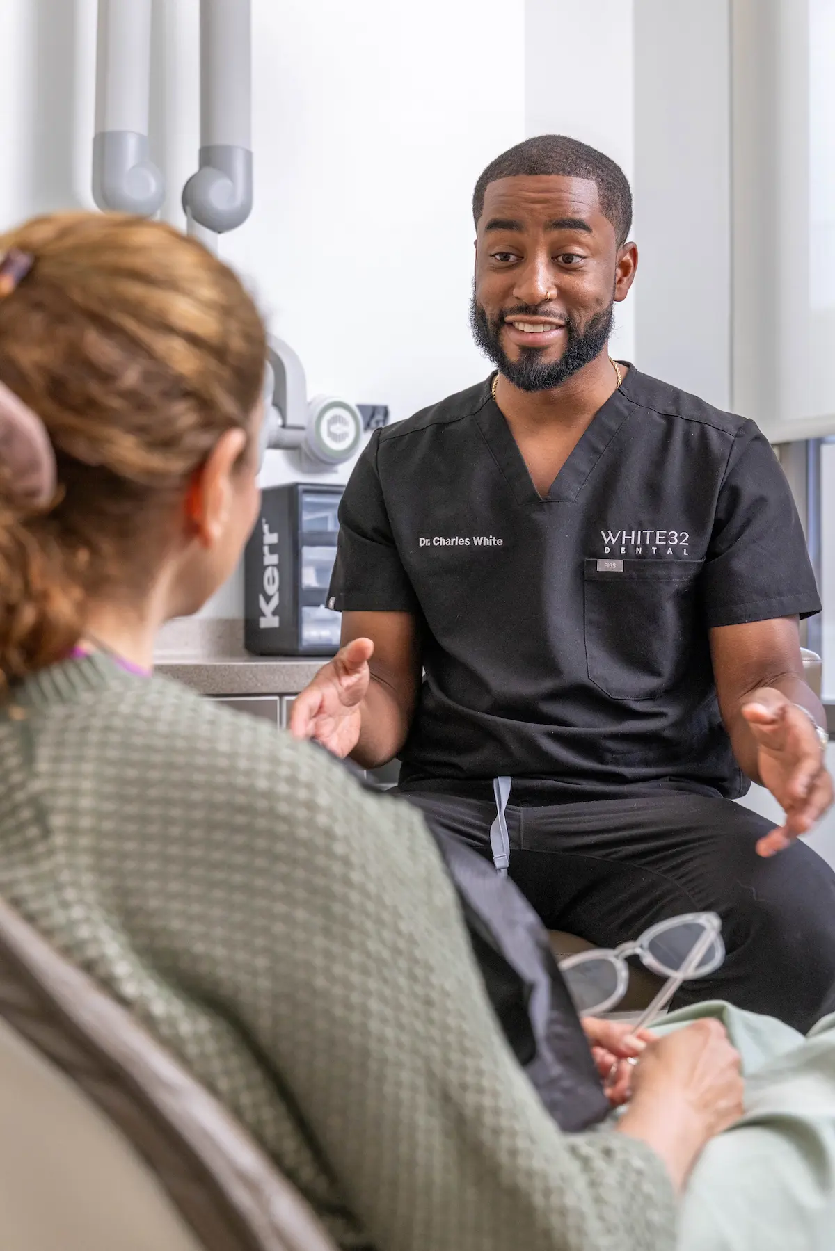 Dr. Charles White talking with a patient at White32 Dental in Foxhall Square