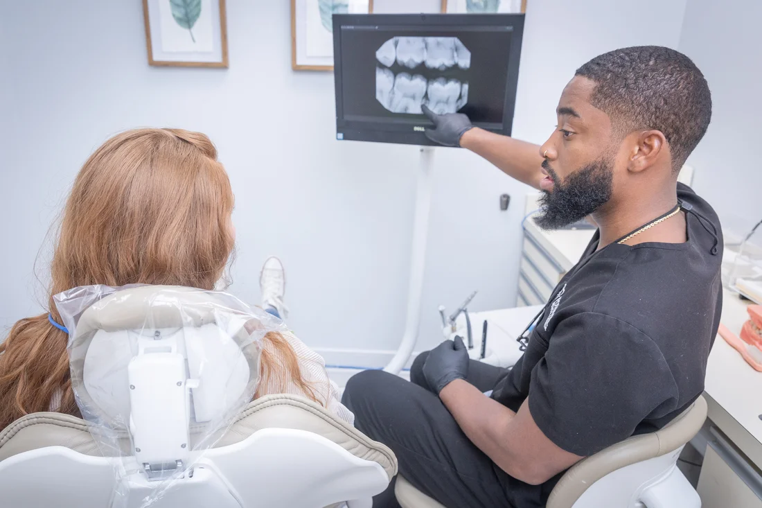 Dr. Charles White reviewing a patient’s dental X-rays on screen