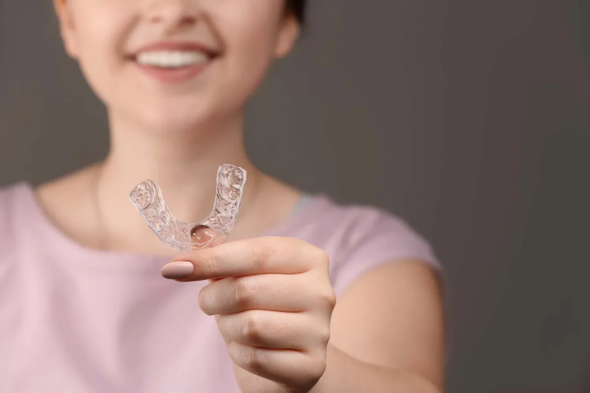 A patient holding a custom clear nightguard