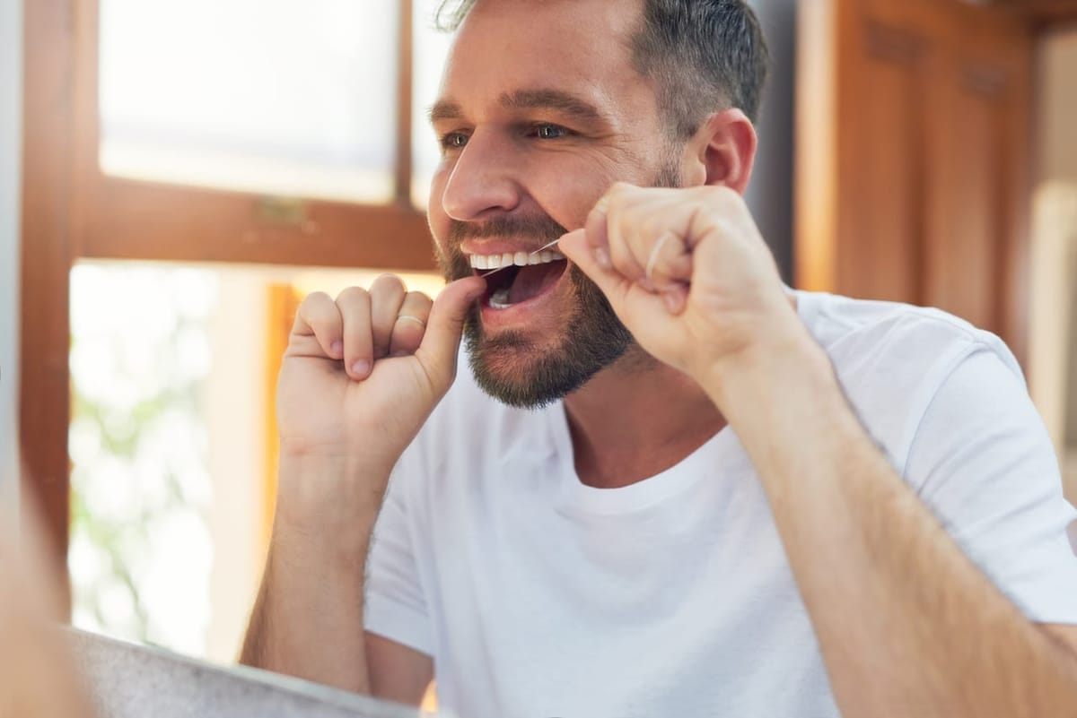 A patient flossing as part of ongoing gum care