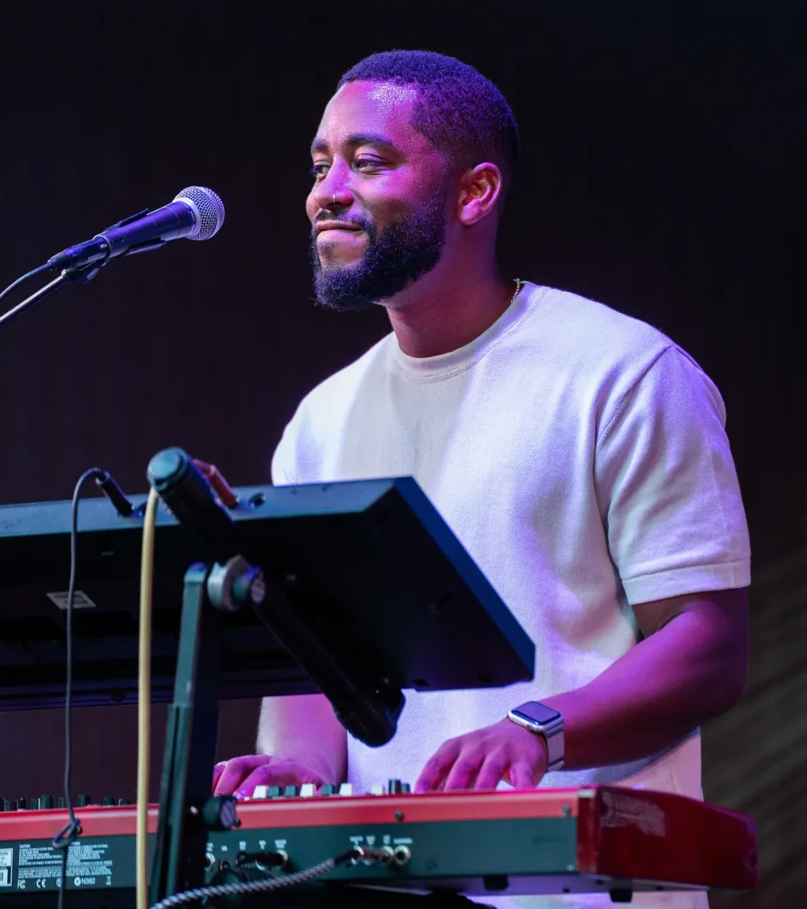 Dr. Charles White playing keyboard at a local venue